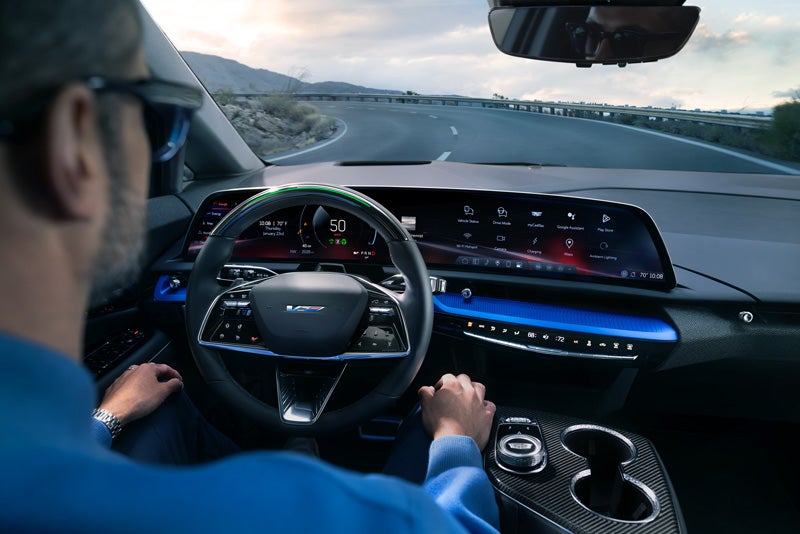 Front View of the 2026 OPTIQ-V Driving Through the Dusk Utilizing its Headlights | Ross Downing Cadillac in HAMMOND LA