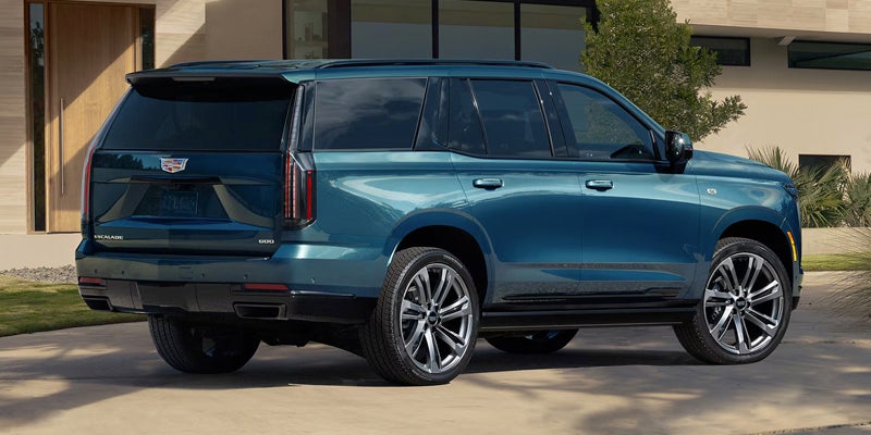 Side view of 2026 Cadillac Escalade parked near house