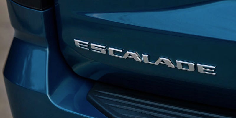 Close-up of the rear badge on a blue 2026 Cadillac Escalade